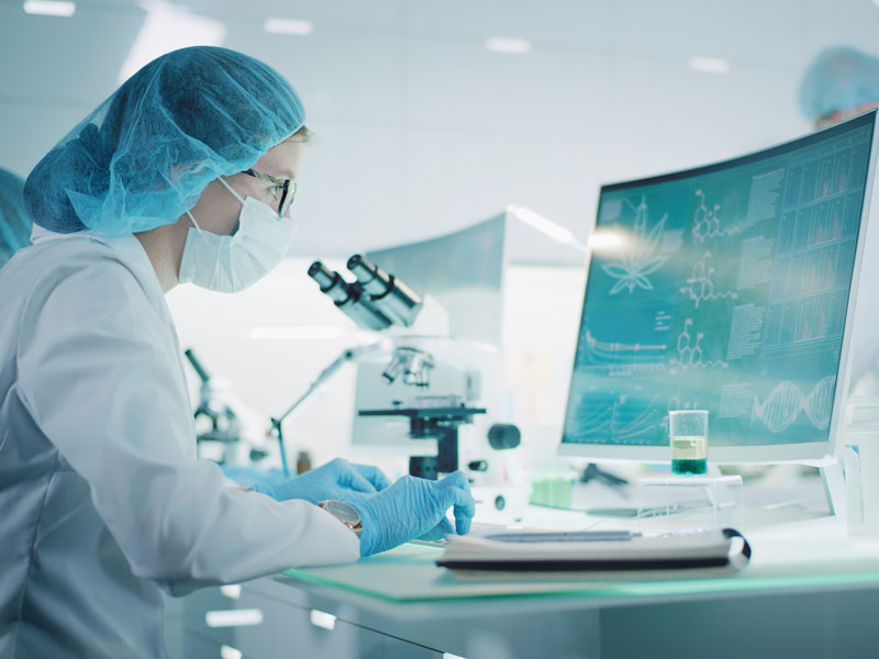 female lab technician inputting data into computer