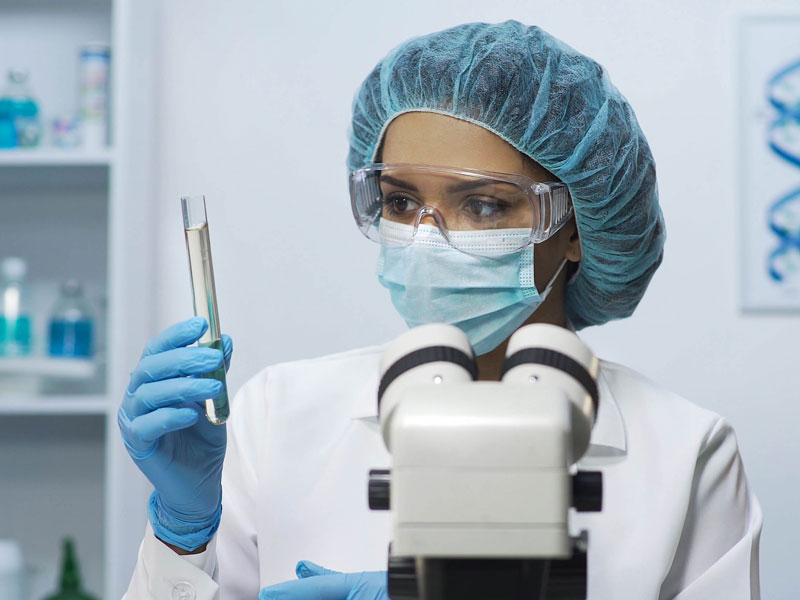 Scientist inspecting test tube of liquid