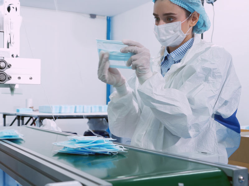 Lab technician inspecting surgical masks